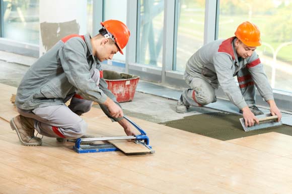 Two tilers at industrial floor tiling renovation